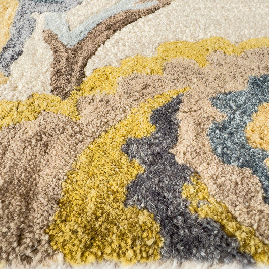Close-up of a textured rug with yellow, gray, and beige colors.