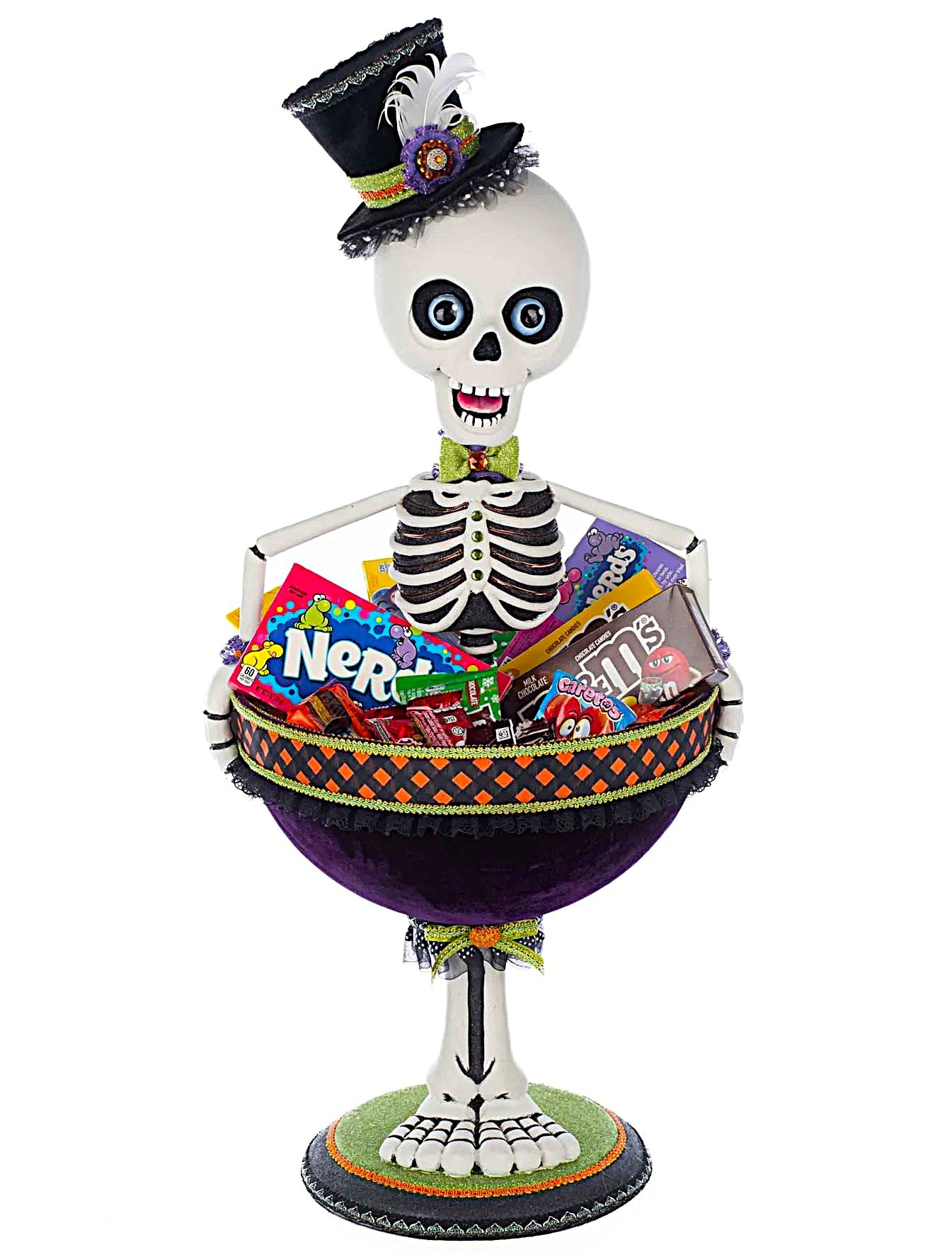 Skeleton figure with a top hat holding a bowl of Halloween candy on a white background