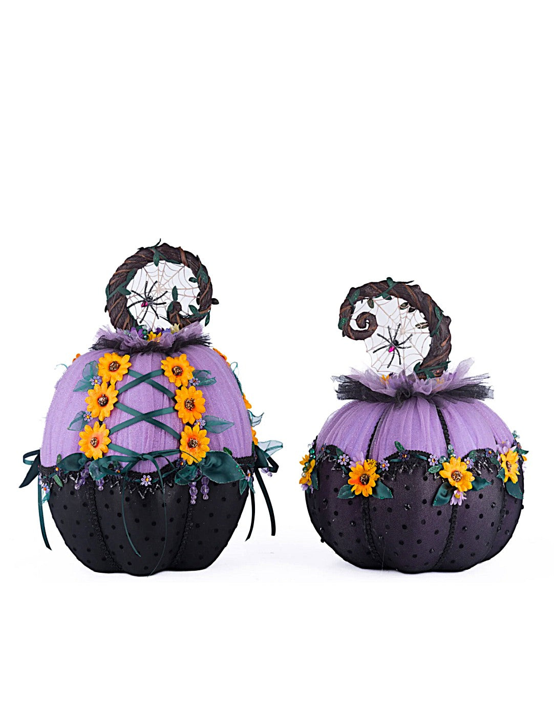Two decorative pumpkins with purple tops, black bodies, and sunflower decorations on a white background.