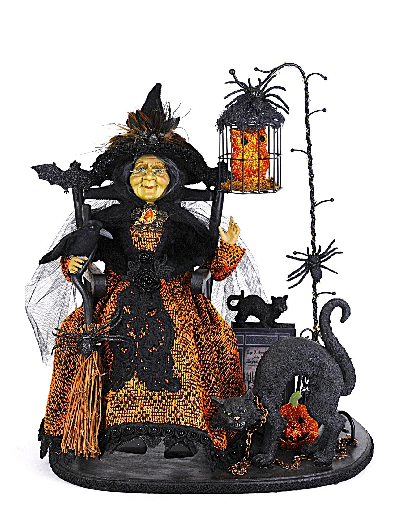Halloween-themed figurine with a witch, black cats, and pumpkins on a white background