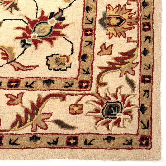 Close-up of a patterned rug with intricate designs on a beige background