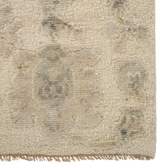 Textured beige rug with a subtle pattern on a white background