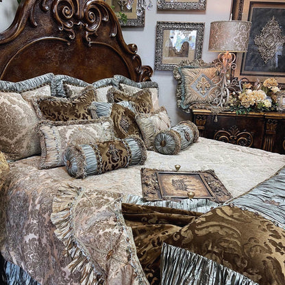 An opulent bedding set featuring a combination of washed chenille, crushed silk, and embossed velvet in grey taupe, milk chocolate brown, and spa green, displayed on a large bed with ornate bedroom furniture in the background.