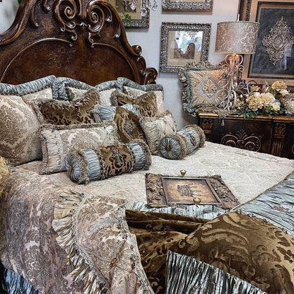 An opulent bedding set featuring a combination of washed chenille, crushed silk, and embossed velvet in grey taupe, milk chocolate brown, and spa green, displayed on a large bed with ornate bedroom furniture in the background.