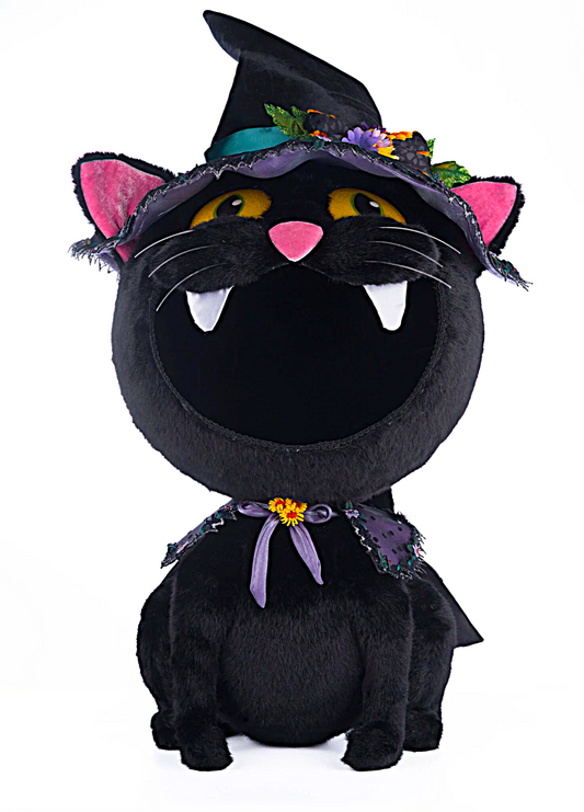 Black cat plush toy with witch hat and purple scarf on a white background