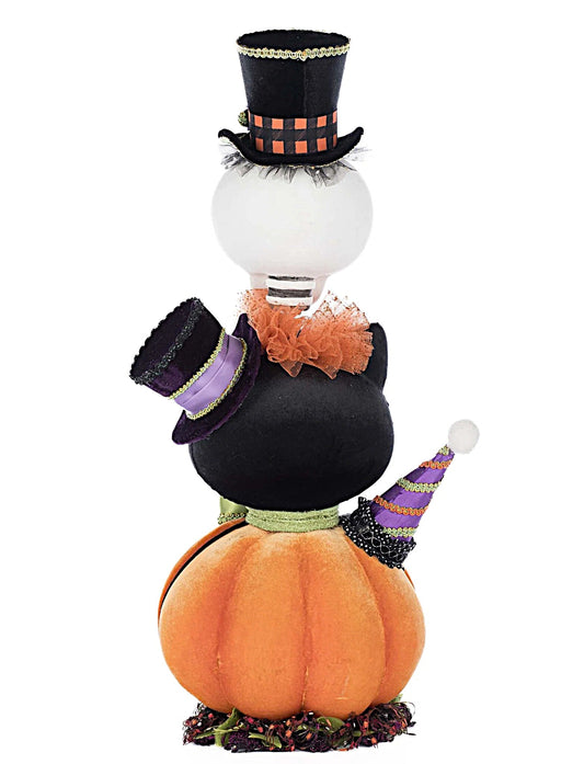 Halloween-themed decoration with a light bulb, pumpkins, and hats on a white background