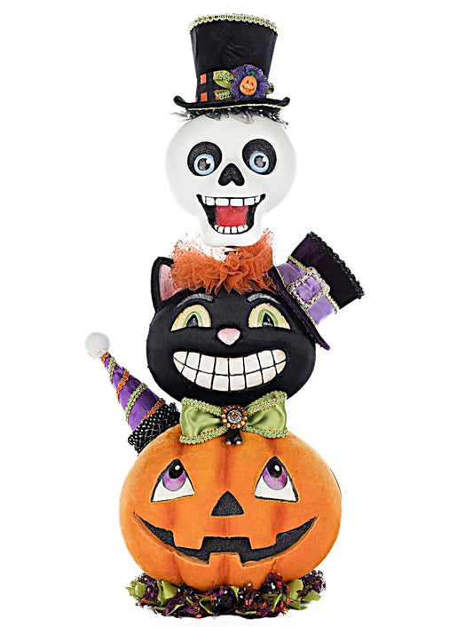 Halloween-themed decoration with a black cat, pumpkin, and skull on a white background