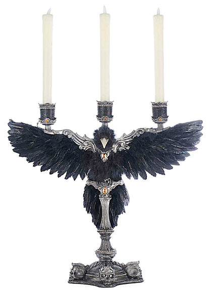 Decorative candle holder with black feathers and silver base on a white background