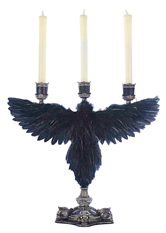 Decorative candle holder with blue feathers and three candles on a white background