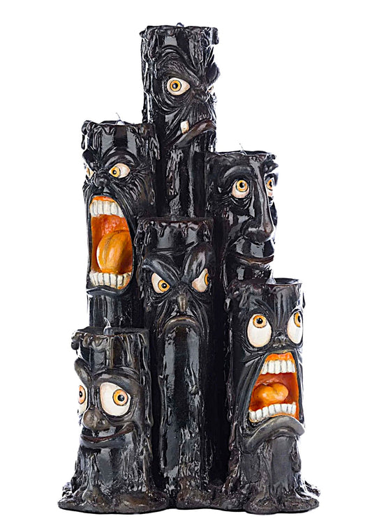 Decorative piece with multiple faces and open mouths on a white background